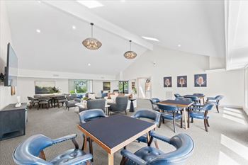 A modern dining room with blue chairs and a wooden table.